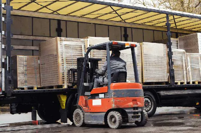 3PL warehouse forklift loading pallets onto trailer