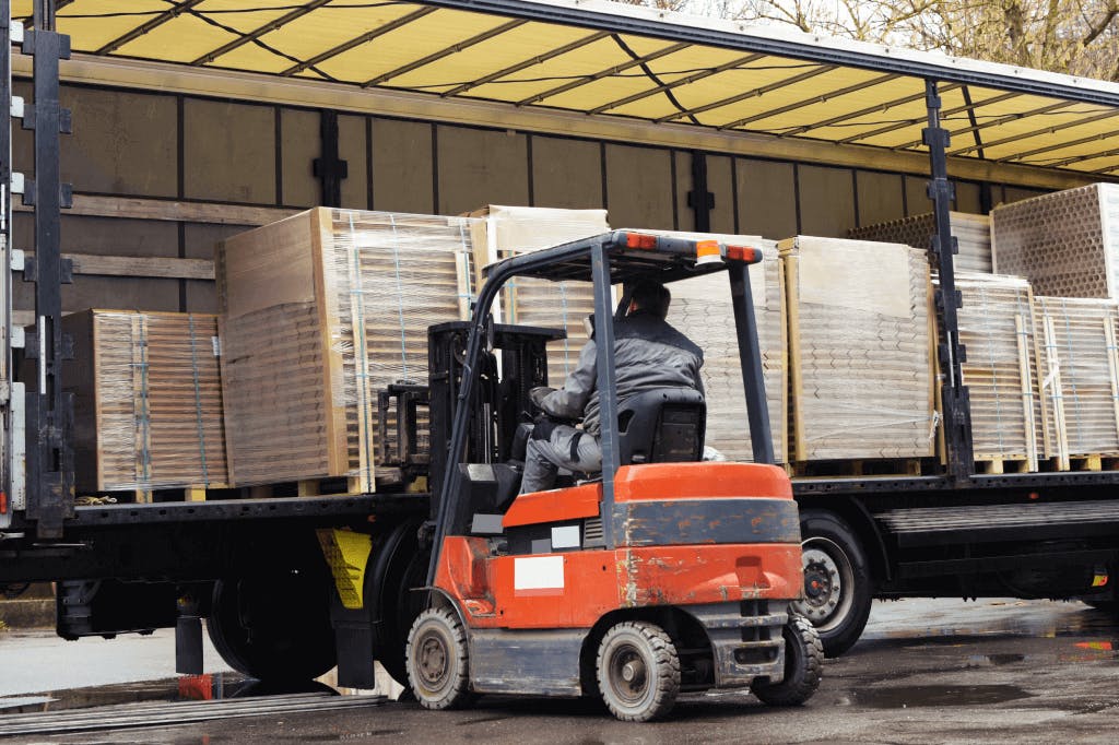 3PL warehouse forklift loading pallets onto trailer