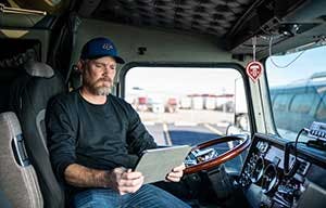 Trucker reviewing invoice.