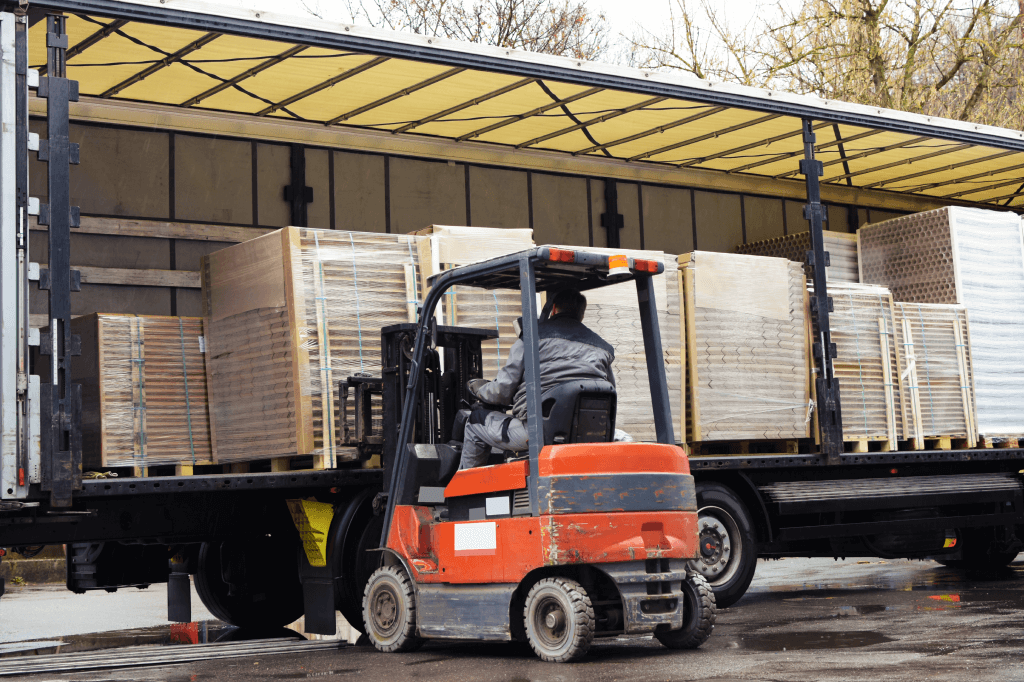 forklift loading pallets onto a trailer