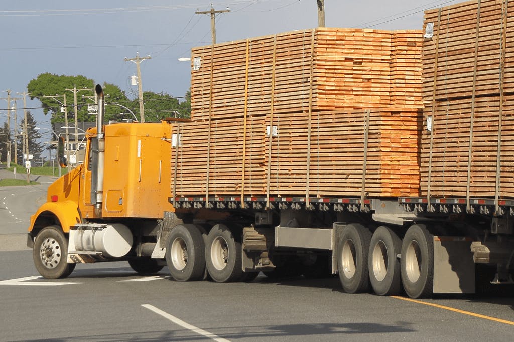 A flatbed truck pulling tandem.