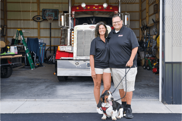 couple with dog infront of truck