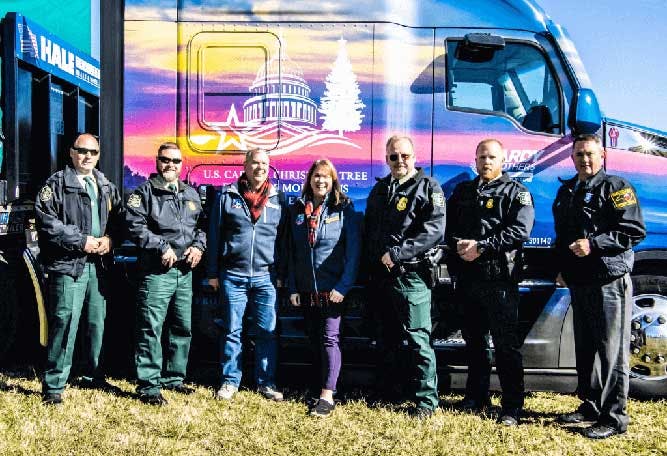 Capital christmas tree team in front of truck