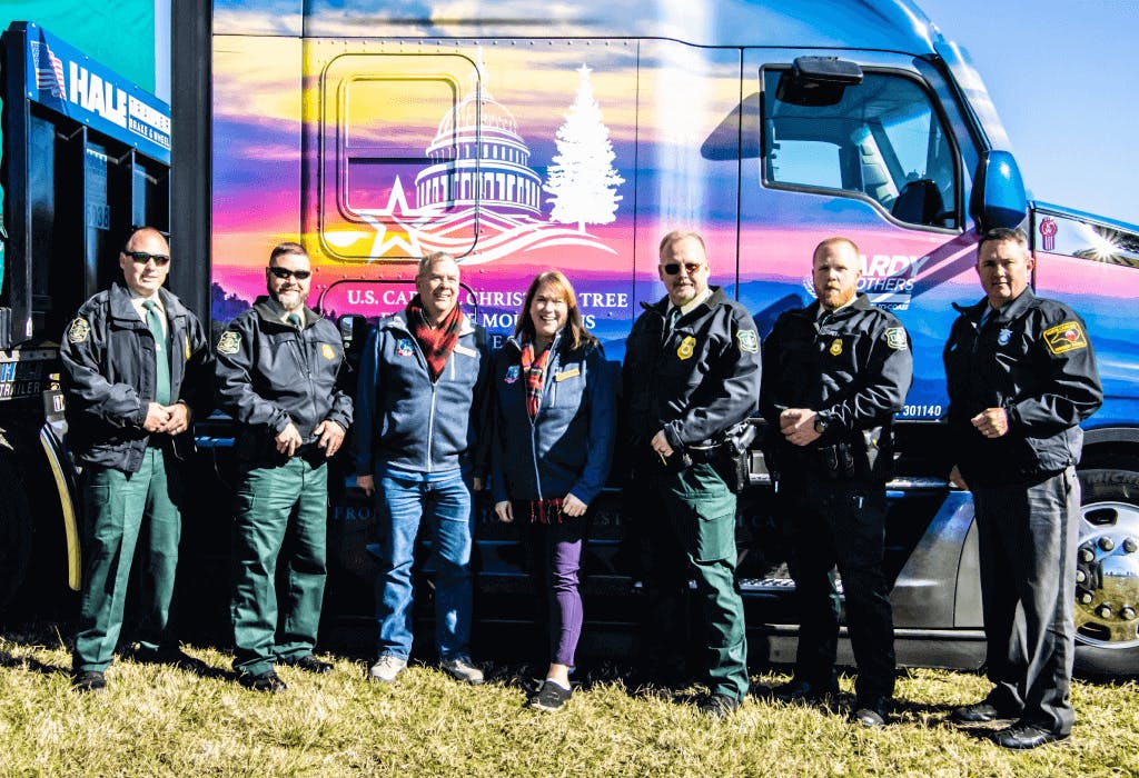 Capital christmas tree team in front of truck