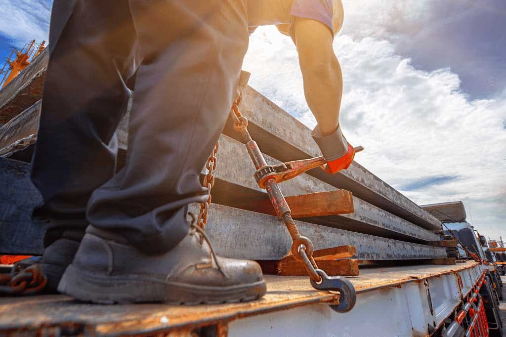 Truckstop.com customer performing safety check straps on a flatbed trailer load.