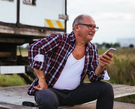 A driver uses truckstop.com factoring to get paid while sitting on his truck.