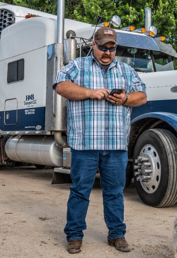 Shane Higgins, Truckstop customer, using his smartphone to find and book loads on the load board for his dry vans.