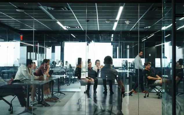 Neon Logistics brokers tracking load activity in an open office