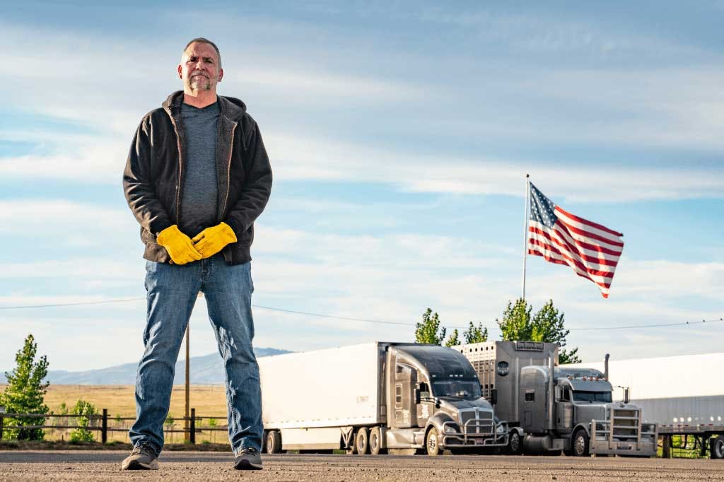 Carrier standing with crossed arms.