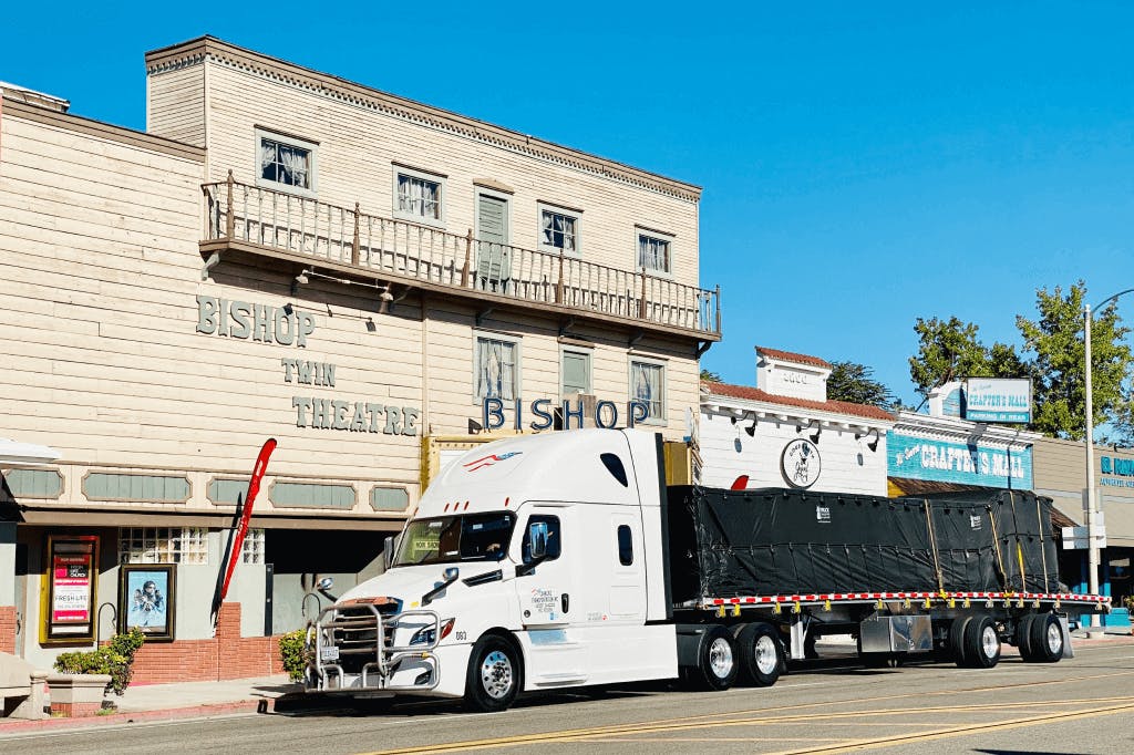 Short-haul flatbed truck parked for business delivery on city street