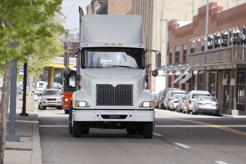 A truck driving down a city street.