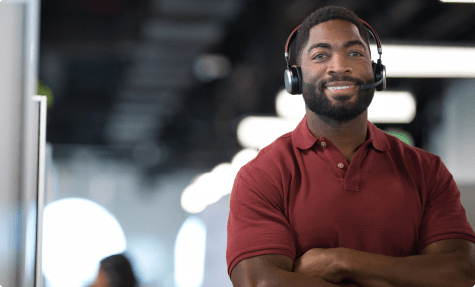 Broker with folded arms wearing a headset.