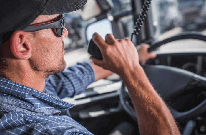 truck driver using CB radio to acknowledge message received